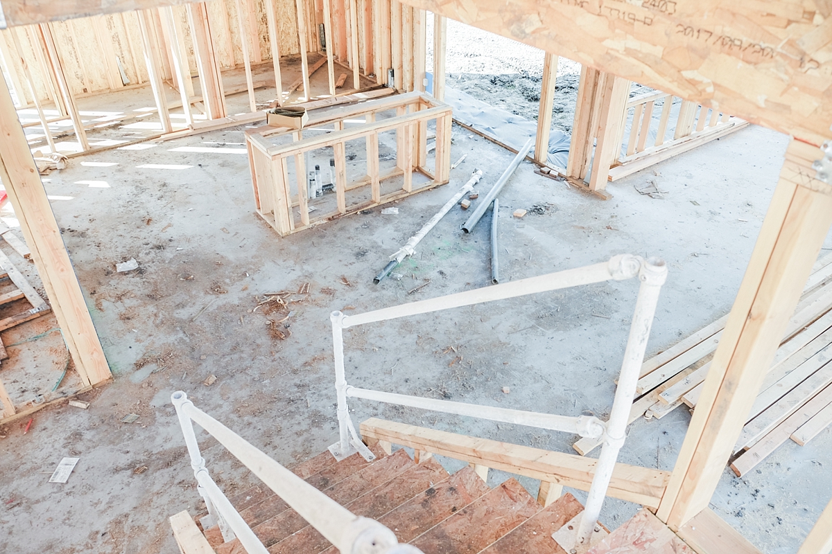 Stairs heading down to kitchen on the left and dining room on the right