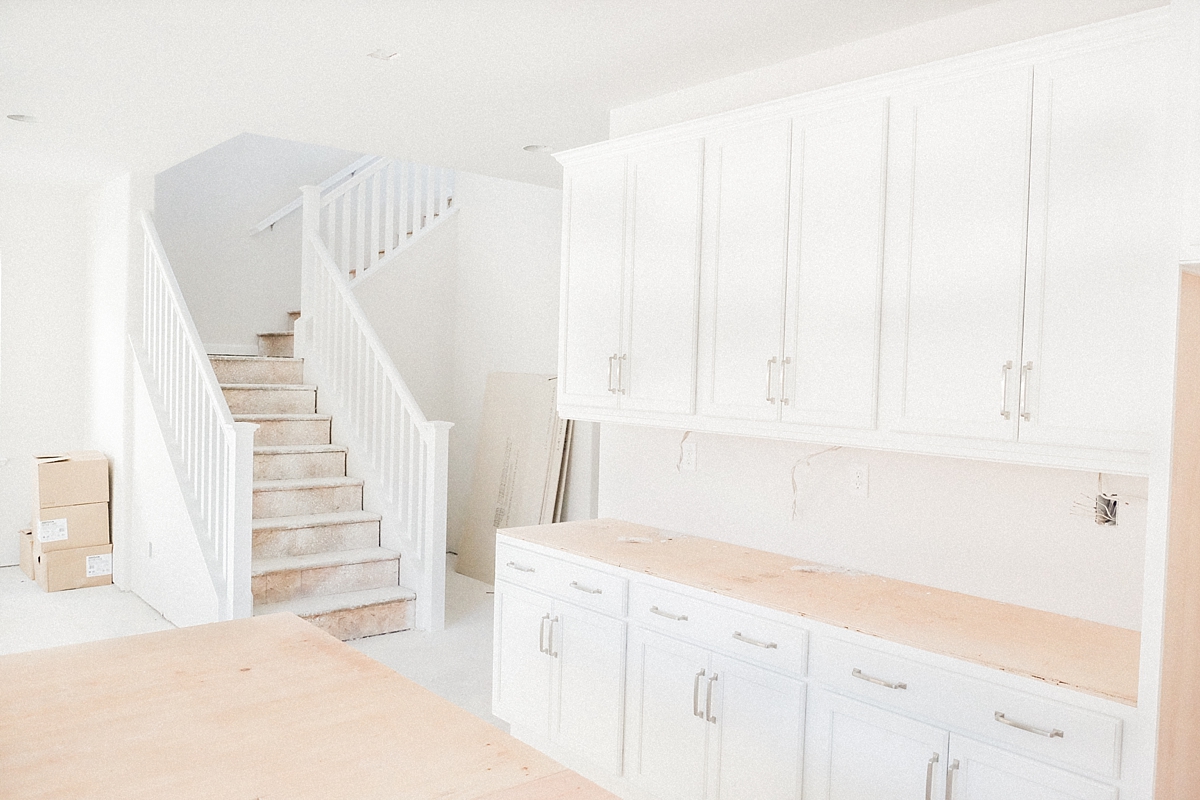 Kitchen with cabinets + stairs railing