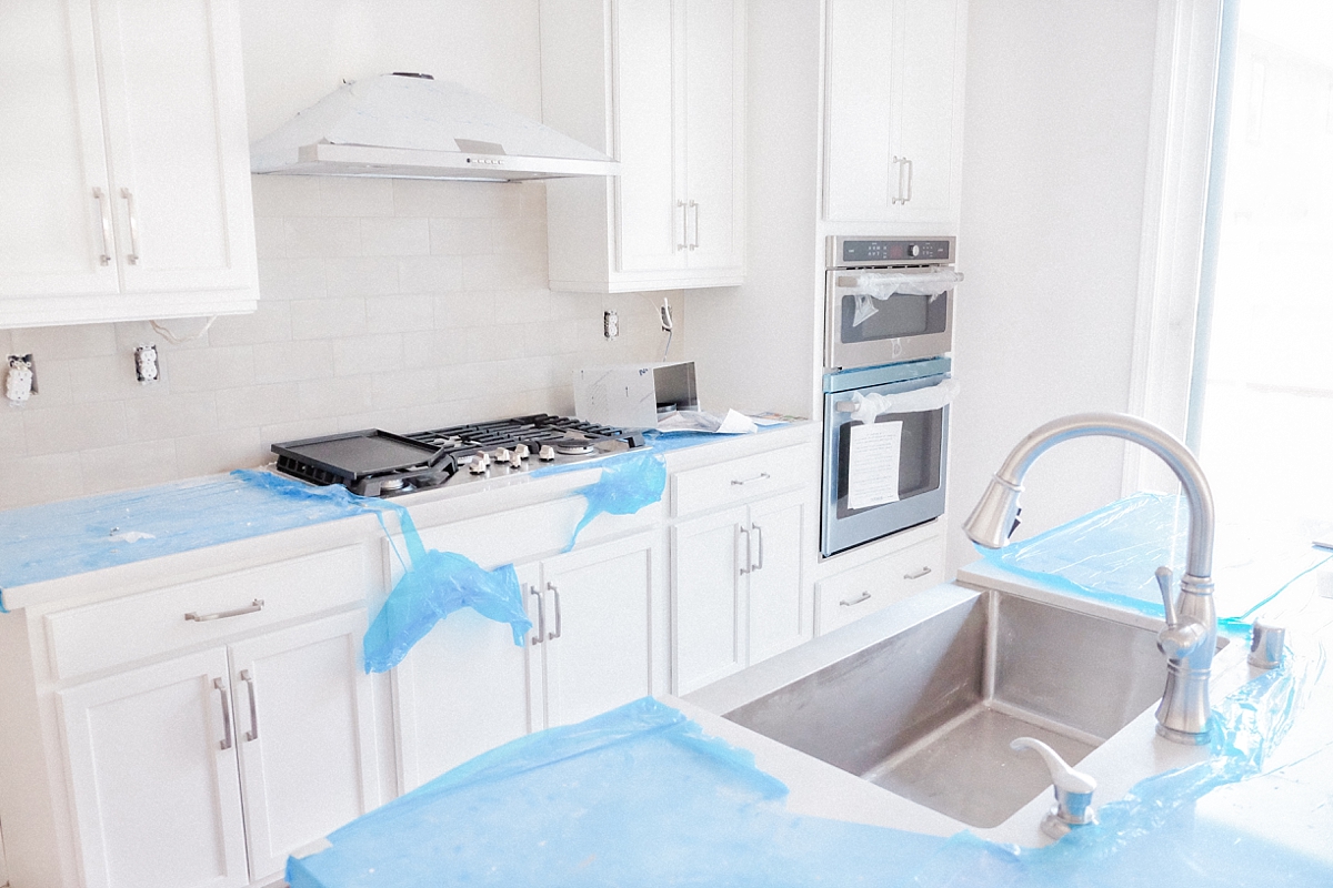 Gourmet kitchen with cooktop, double over and hood