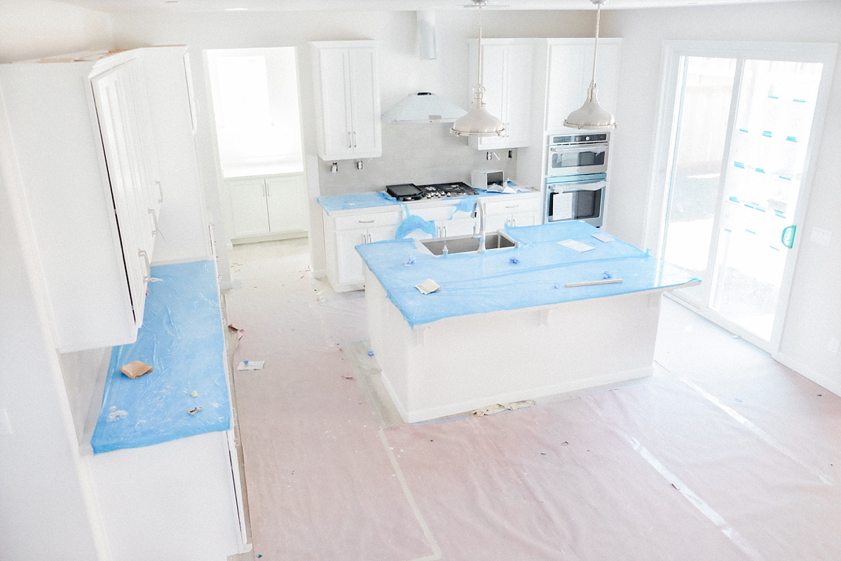 Gourmet kitchen with backsplash, cooktop, double over and hood