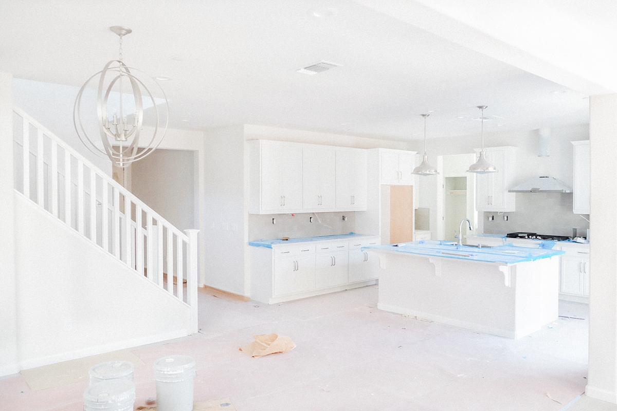 Gourmet kitchen with backsplash, cooktop, double over and hood