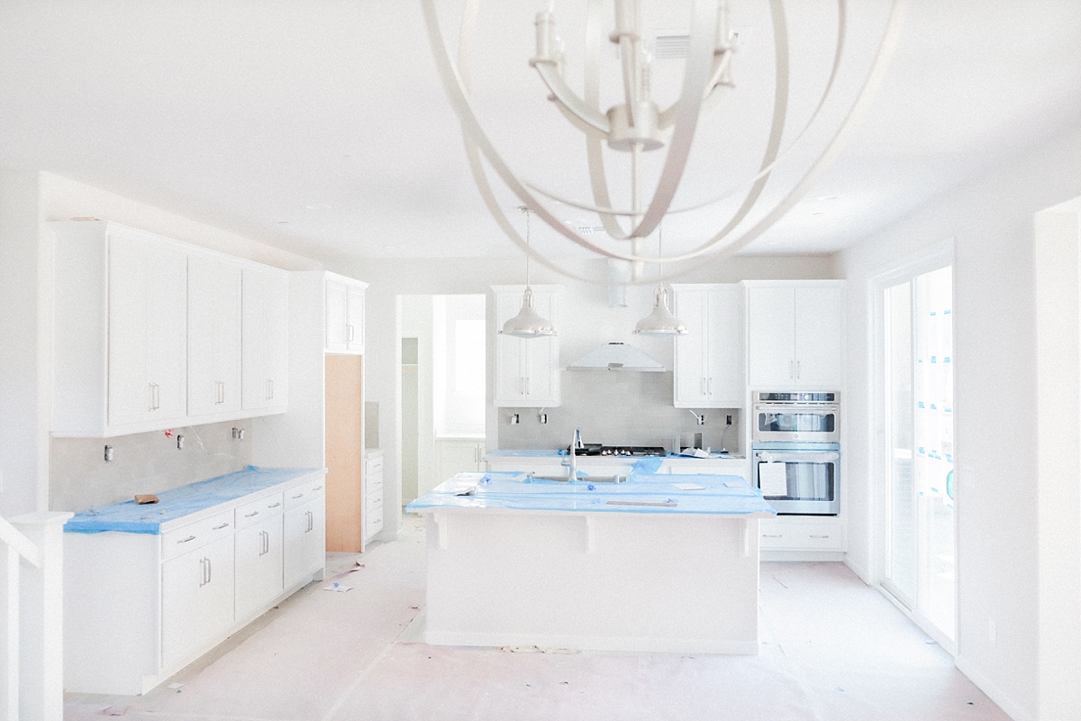 Gourmet kitchen with backsplash, cooktop, double over and hood